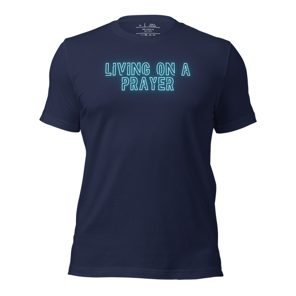 3D mockup of 'Living on a Prayer' T-shirt, featuring neon text on navy fabric.