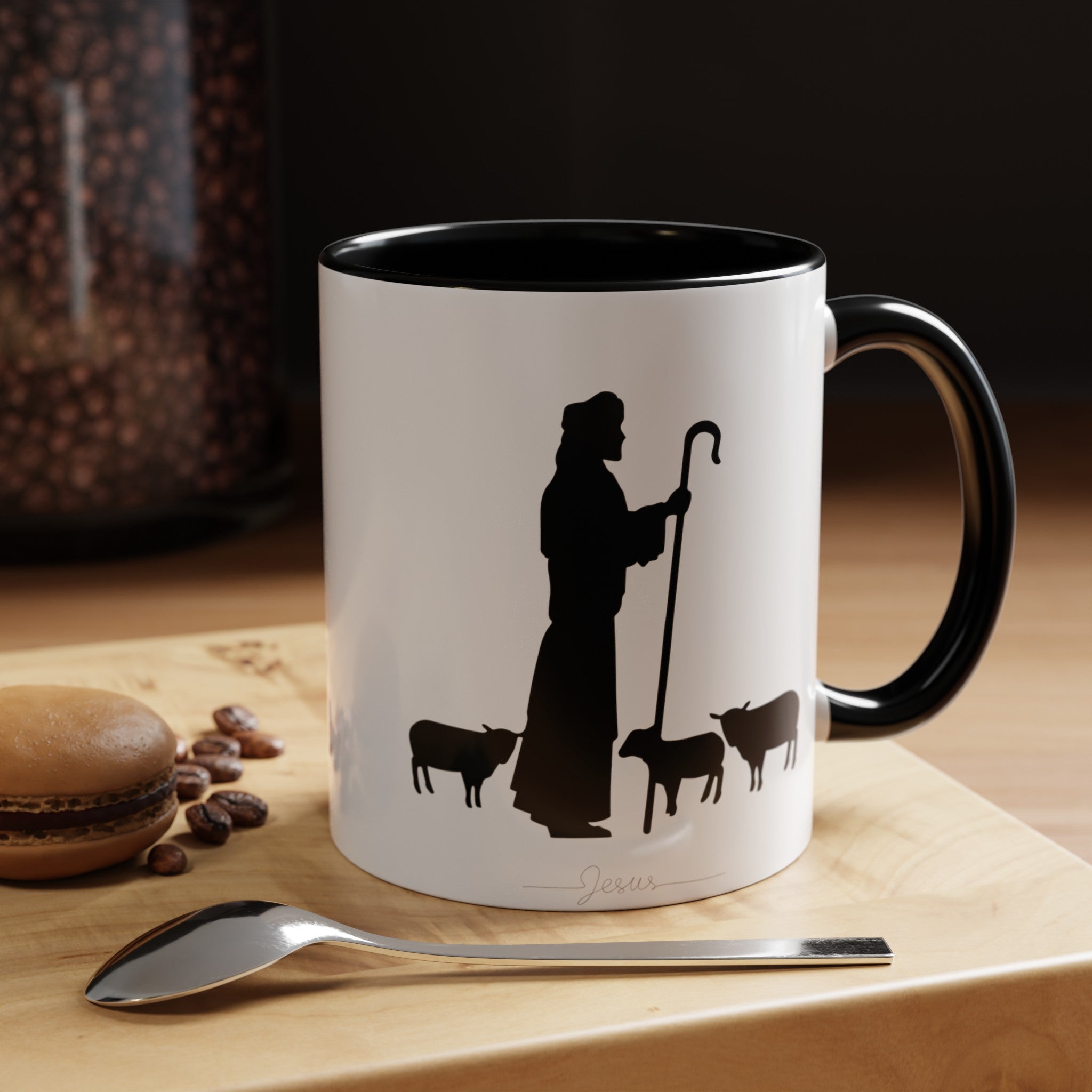 Front of the White Mug with Black Interior on Wood Table: "White ceramic coffee mug with black interior featuring a minimalist black ink design of Jesus with sheep. Displayed on a rustic wood table, this 11oz or 15oz mug is perfect for adding spiritual inspiration to your morning routine."