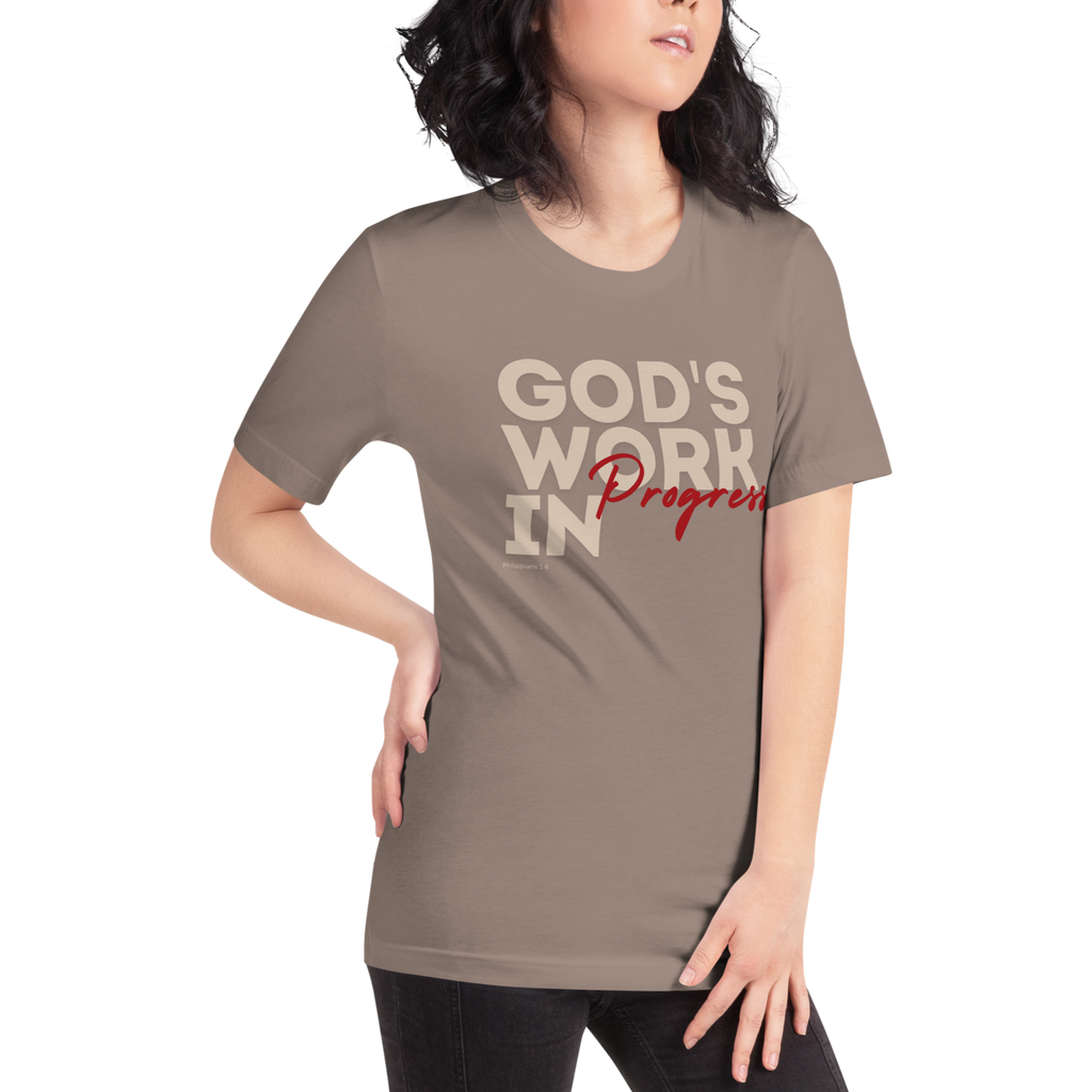 Female model wearing Heavenly Crafted's 'God's Work in Progress' T-shirt in Tan, offering a stylish and comfortable look that symbolizes personal growth and faith.