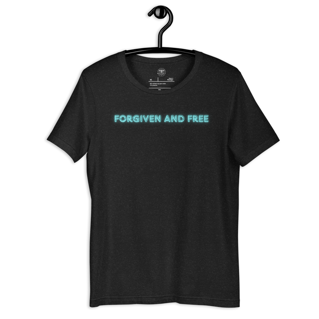 Heavenly Crafted's 'Forgiven and Free' T-shirt in Black Heather hanging on a wooden hanger, showcasing the sleek design with vibrant neon blue text. Perfect for everyday faith expression.