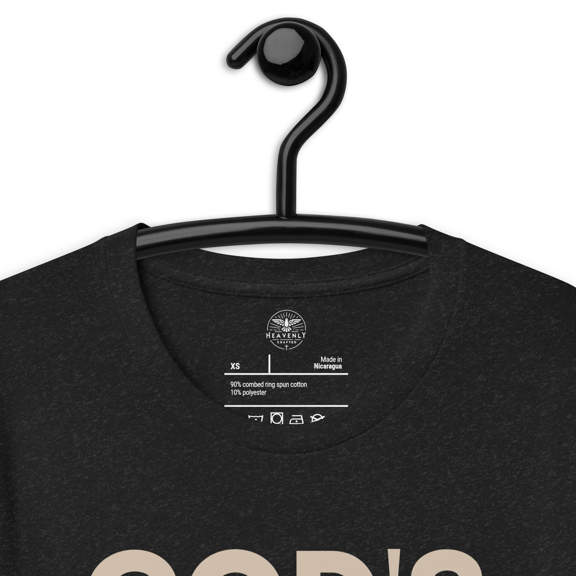 Heavenly Crafted's 'God's Work in Progress' T-shirt in Charcoal Black hanging on a wooden hanger, featuring a simple and bold text design. Perfect for expressing faith and embracing growth.