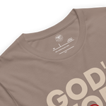 Brand and care instructions label inside Heavenly Crafted's 'God's Work in Progress' T-shirt in Tan. Displays high-quality fabric details and care guidelines to maintain this soft, durable tee.