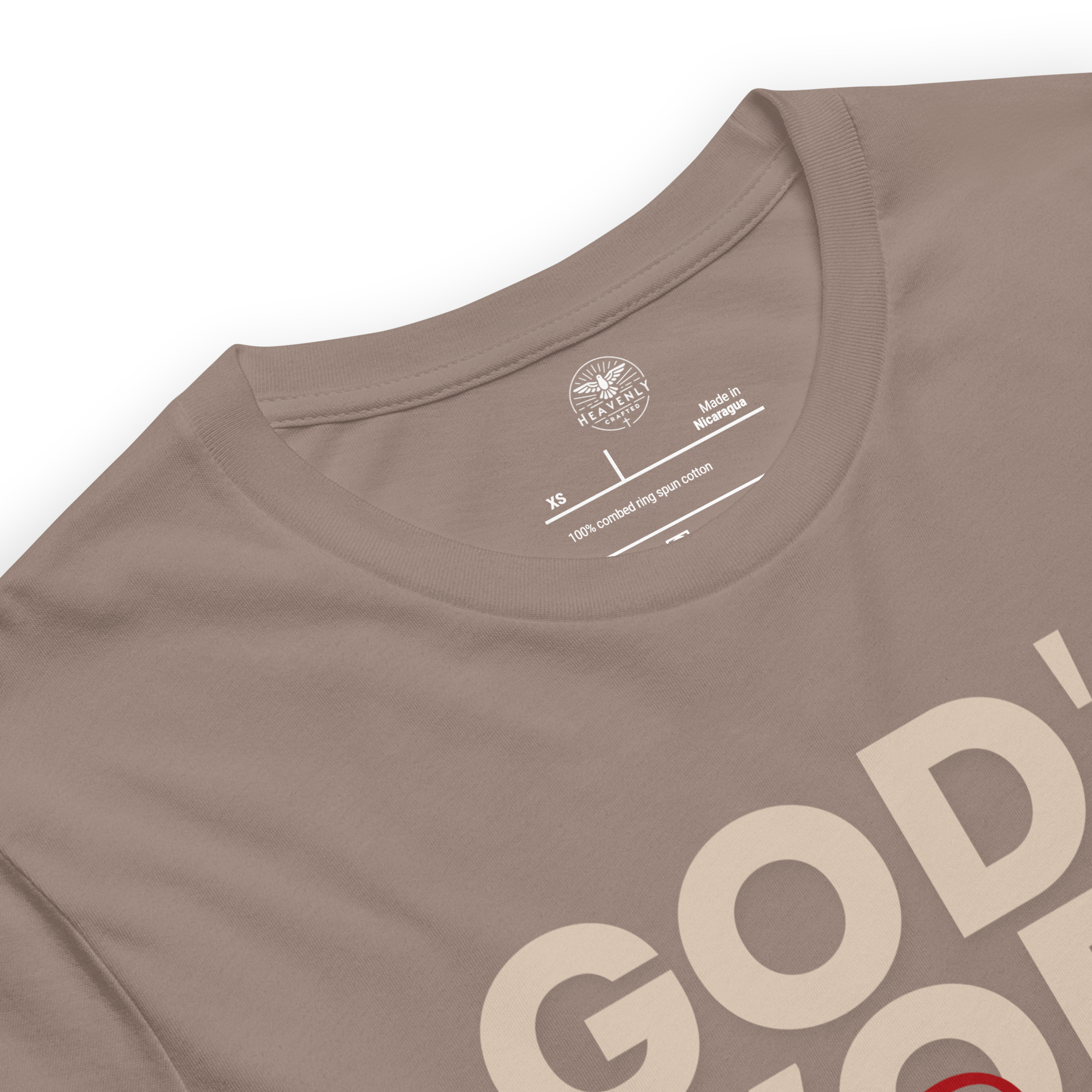 Brand and care instructions label inside Heavenly Crafted's 'God's Work in Progress' T-shirt in Tan. Displays high-quality fabric details and care guidelines to maintain this soft, durable tee.