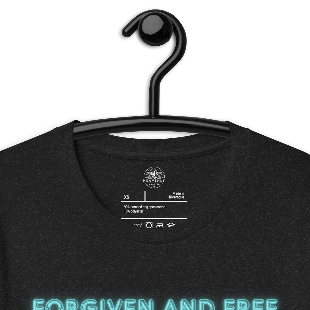 Inside label of Heavenly Crafted's 'Forgiven and Free' T-shirt, detailing fabric composition and care instructions. Made with premium quality for a comfortable and durable wear.