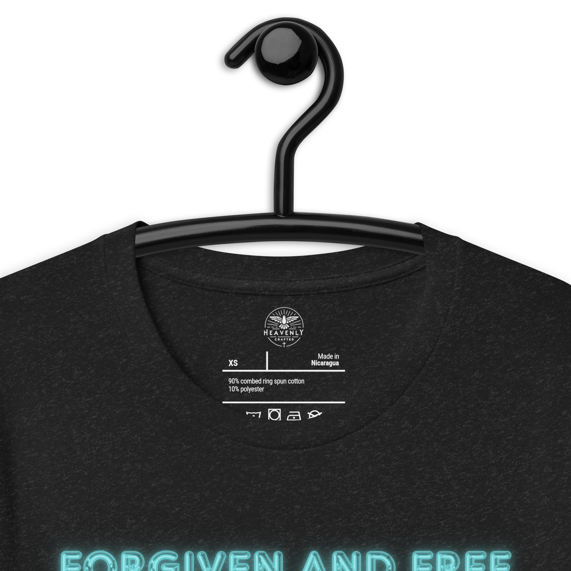 Inside label of Heavenly Crafted's 'Forgiven and Free' T-shirt, detailing fabric composition and care instructions. Made with premium quality for a comfortable and durable wear.