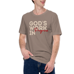 Male model wearing Heavenly Crafted's 'God's Work in Progress' T-shirt in Tan, offering a stylish and comfortable look that symbolizes personal growth and faith