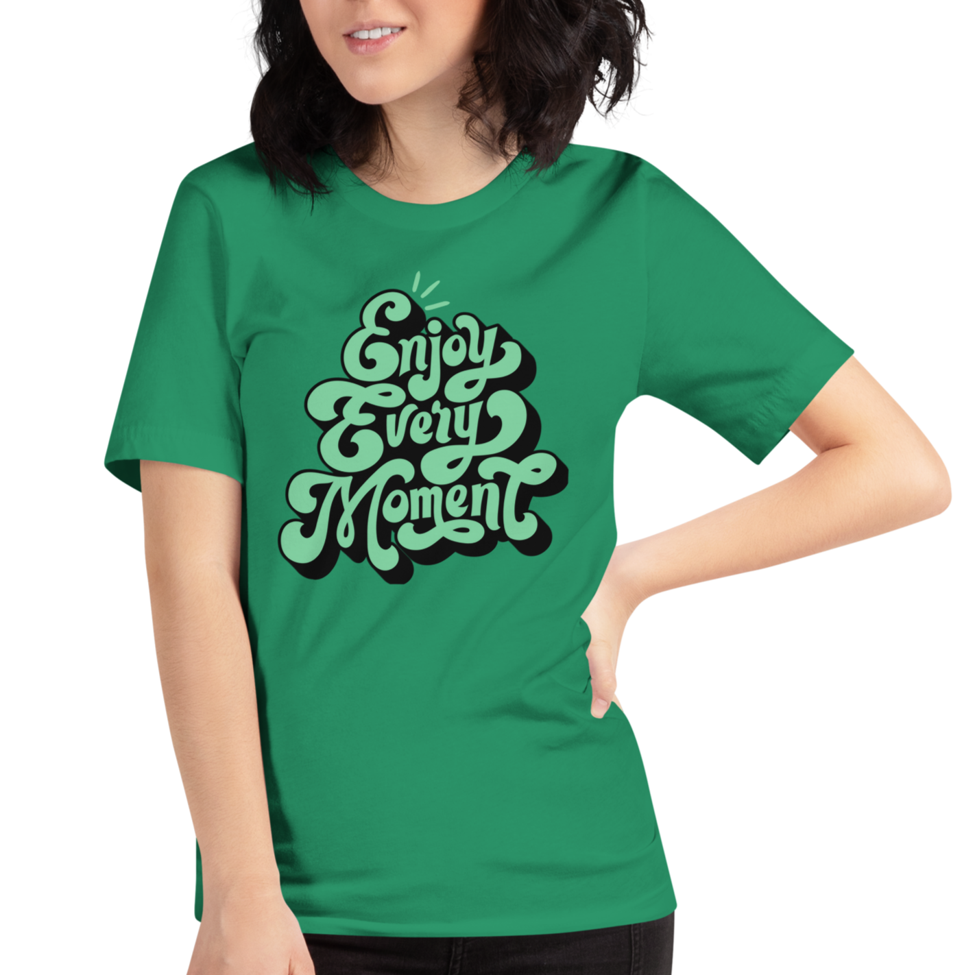 Model wearing 'Enjoy Every Moment' T-shirt in vibrant green, three-quarter view. Features bold graffiti-style lettering and a comfortable, flattering fit.