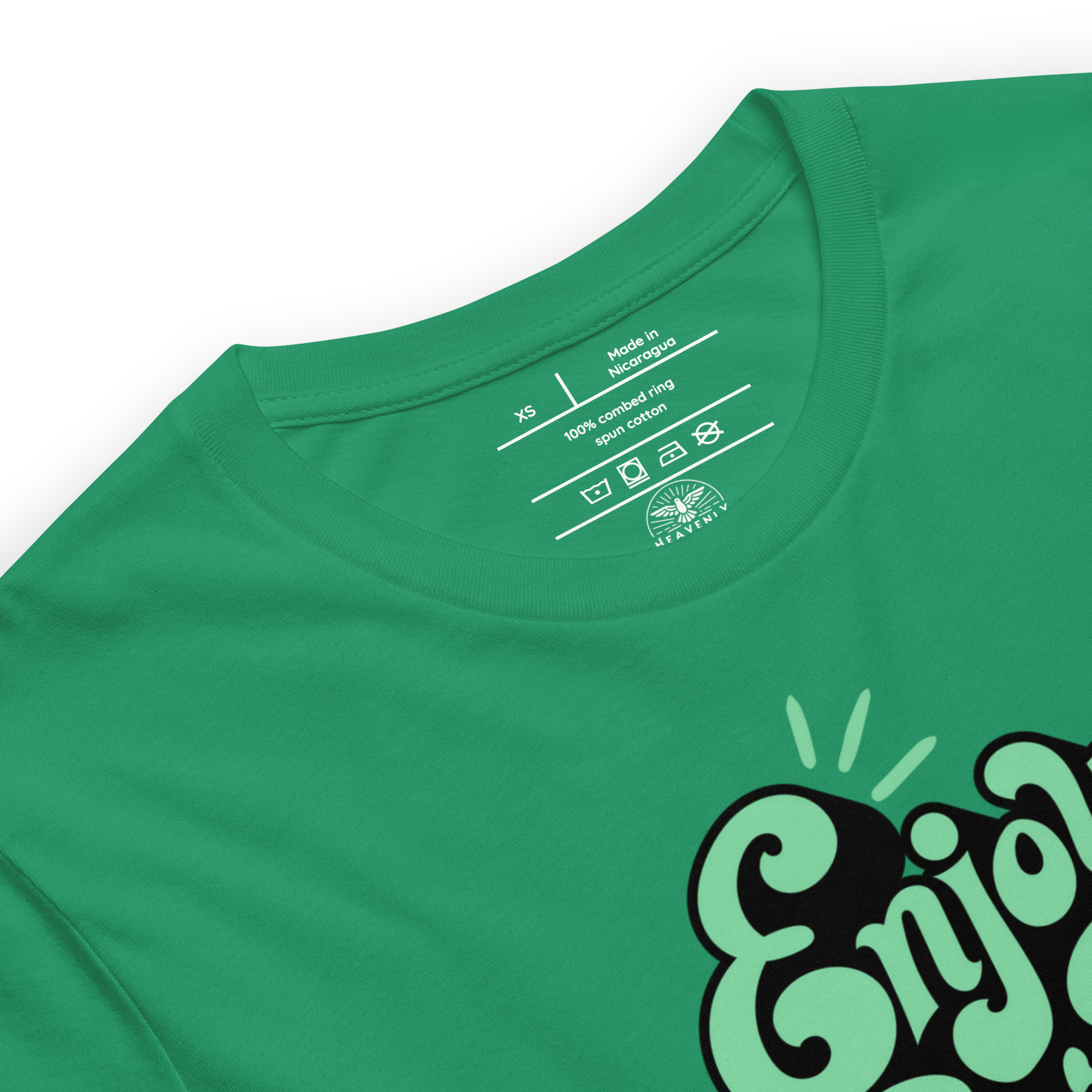 Folded green T-shirt with 'Enjoy Every Moment' in graffiti script, showcasing the vibrant design and soft, quality fabric perfect for daily wear and inspiration.