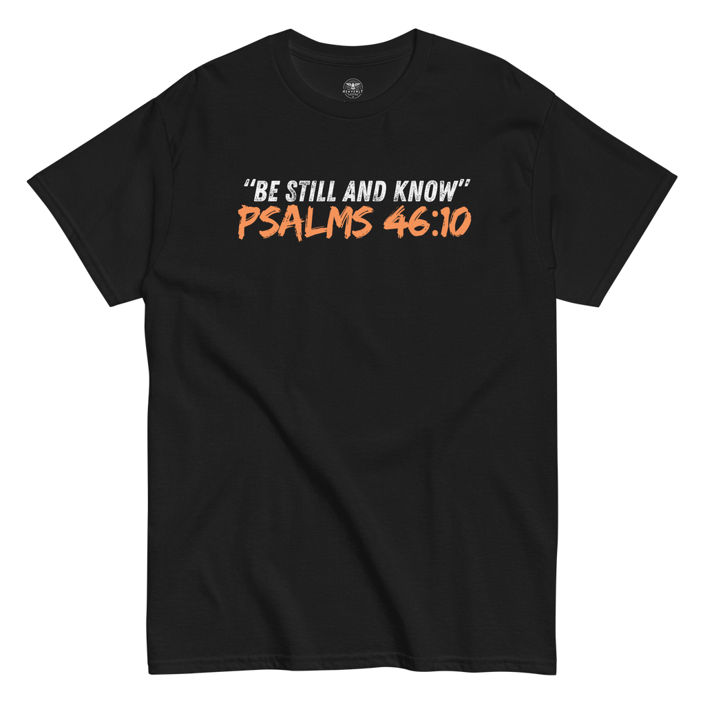 Flat lay of the black 'Be Still And Know' T-shirt with Psalm 46:10 text. Showcasing a minimalist design, this tee offers a serene and inspirational message, perfect for daily wear. Made for comfort and spiritual reflection, it's a versatile addition to any faith-based wardrobe.