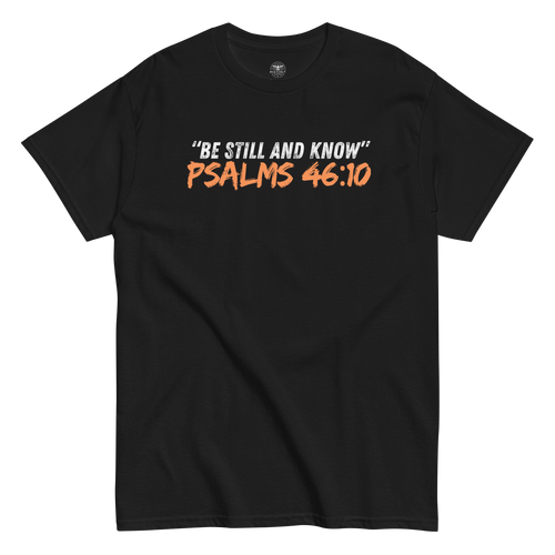 Flat lay of the black 'Be Still And Know' T-shirt with Psalm 46:10 text. Showcasing a minimalist design, this tee offers a serene and inspirational message, perfect for daily wear. Made for comfort and spiritual reflection, it's a versatile addition to any faith-based wardrobe.