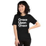 Model wearing 'Grace Upon Grace' T-shirt, three-quarter view. Female