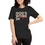 Model wearing 'God's Work in Progress' T-shirt in Charcoal Black, three-quarter view - Female pose