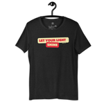 Black Heather 'Let Your Light Shine' T-shirt hanging on a wooden hanger, featuring bold yellow script lettering. Made from soft, breathable cotton, this shirt offers a stylish way to express faith and inspiration.