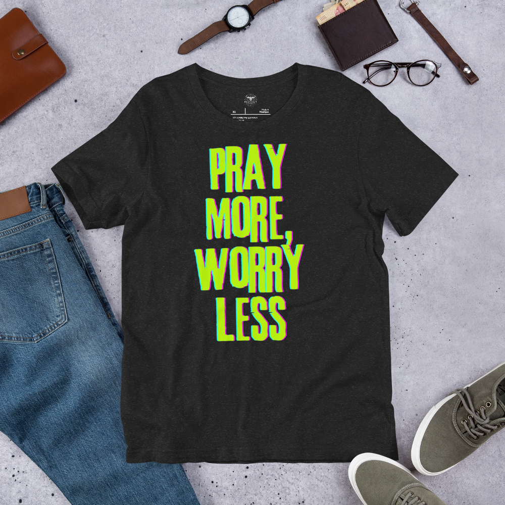 Shop display featuring the 'Pray More Worry Less' T-shirt in eye-catching neon text.
