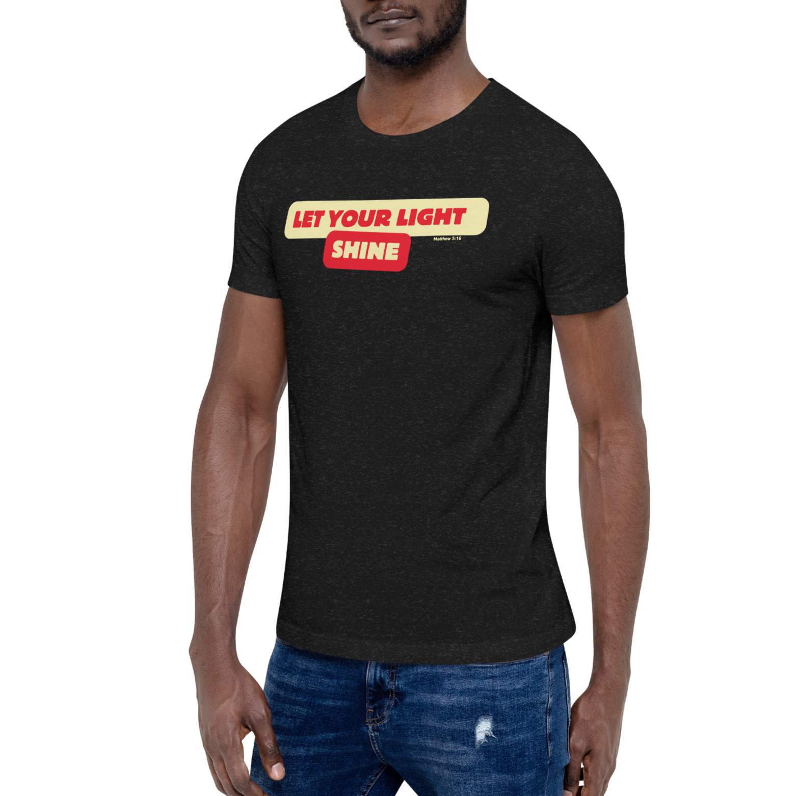 Model wearing the 'Let Your Light Shine' T-shirt in Black Heather, shown from a three-quarter view. Features bold yellow script lettering, inspired by Matthew 5:16, on soft, breathable cotton for a comfortable and stylish expression of faith.