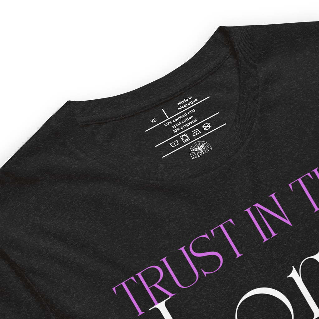 Logo stamp inside 'Trust in the Lord' T-shirt in Black Heather, showing brand and care instructions.