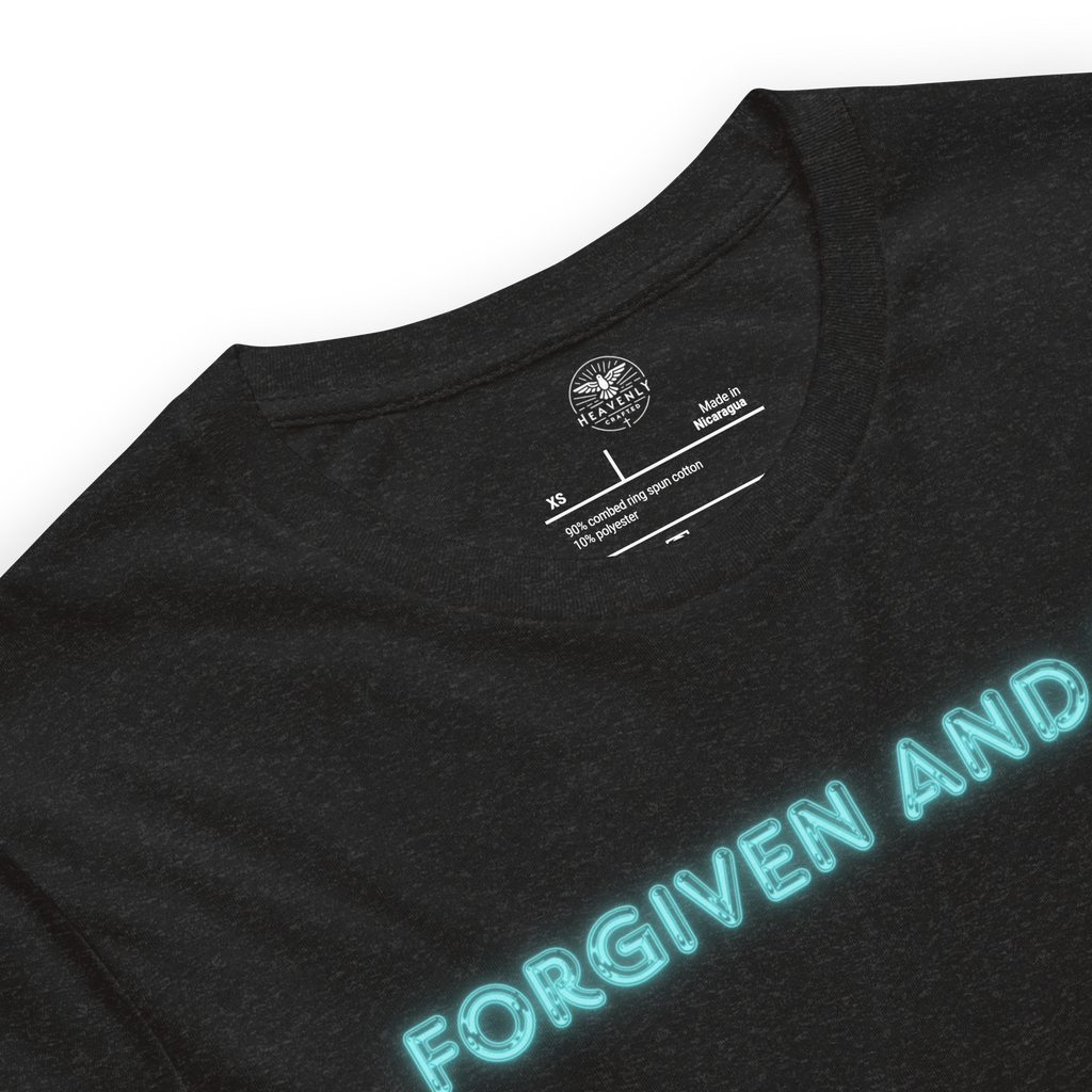 "Inside label of 'Forgiven and Free' T-shirt, detailing fabric and care instructions.