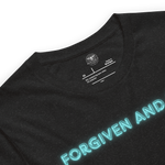 "Inside label of 'Forgiven and Free' T-shirt, detailing fabric and care instructions.