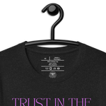 Logo stamp inside 'Trust in the Lord' T-shirt in Black Heather, showing brand and care instructions, on a hanger.