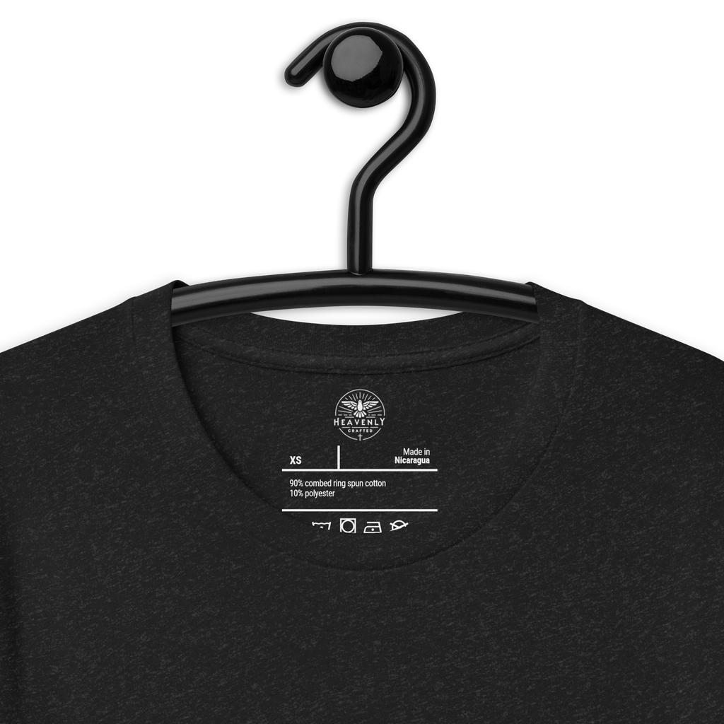 Logo stamp inside Black Heather 'Saved by Grace Through Faith' T-shirt, showing brand and care instructions., on a hanger. close angle