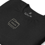 Folded Gospel Noir Filed Under Grace Ephesians 2:8 vintage black Christian t-shirt. Close-up of Filed Under Grace folder tab graphic on Gospel Noir Christian t-shirt