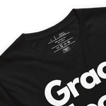 "Logo stamp inside 'Grace Upon Grace' T-shirt, showing brand and care instructions.