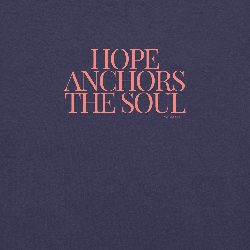 Close-up of 'Hope Anchors the Soul' text in pink on Heather Midnight Navy T-shirt.