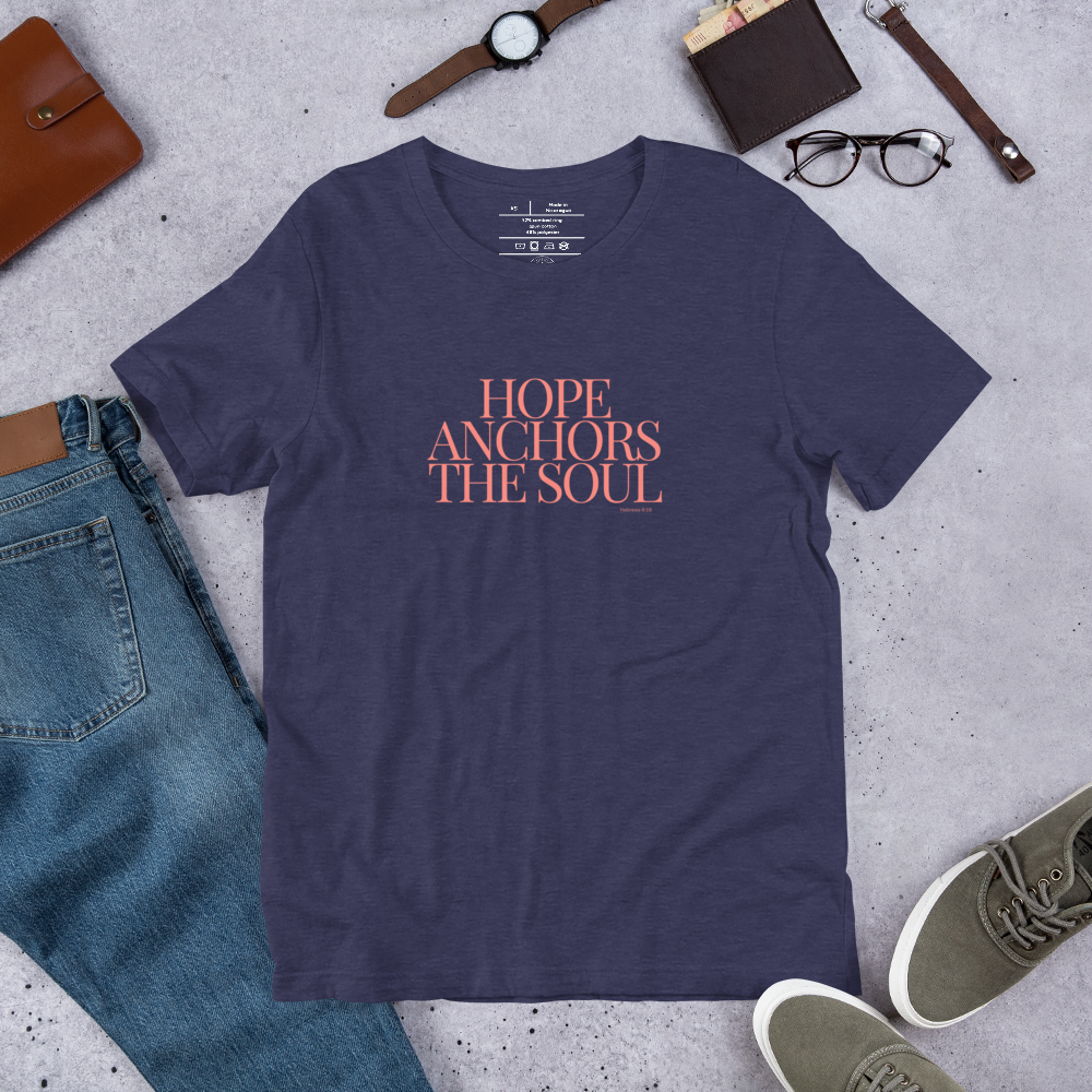 Shop display of 'Hope Anchors the Soul' T-shirt in Heather Midnight Navy with pink text.