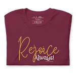 Folded black T-shirt with 'Rejoice Always' in white script.