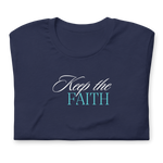 Folded navy T-shirt with 'Keep the Faith' in white script