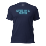 3D mockup of 'Living on a Prayer' T-shirt, featuring neon text on navy fabric.