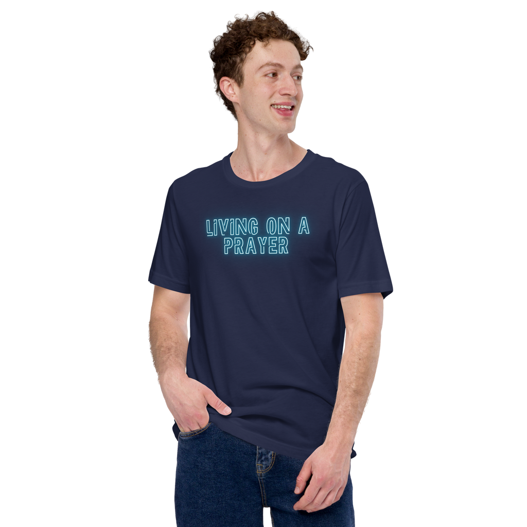 Model wearing 'Living on a Prayer' neon glow T-shirt, three-quarter view, showcasing vibrant design.