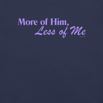 Inside label of 'More of Him, Less of Me' T-shirt showing brand and care details.