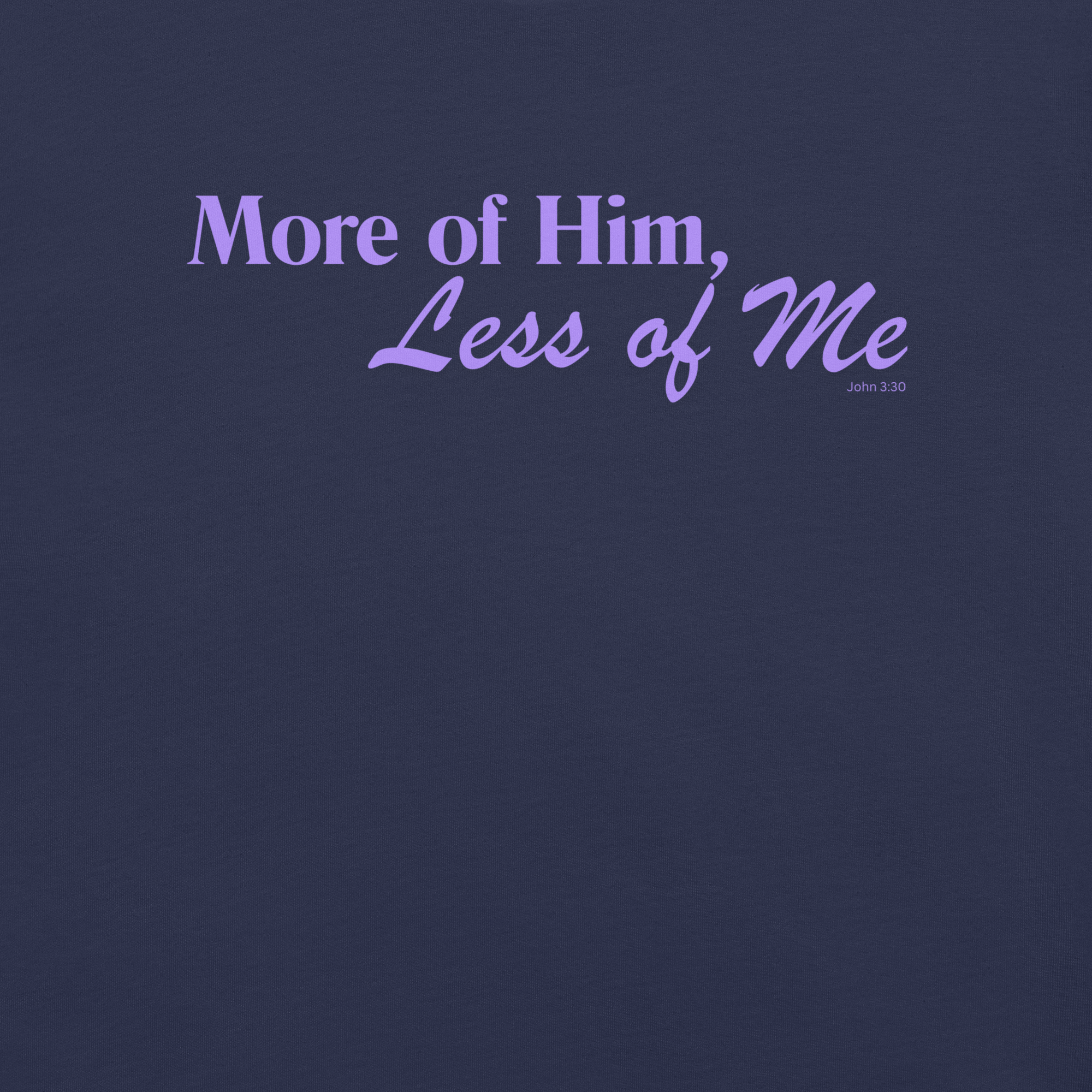 Inside label of 'More of Him, Less of Me' T-shirt showing brand and care details.