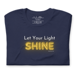Front view of 'Let Your Light Shine' T-shirt, navy blue with glowing yellow text.