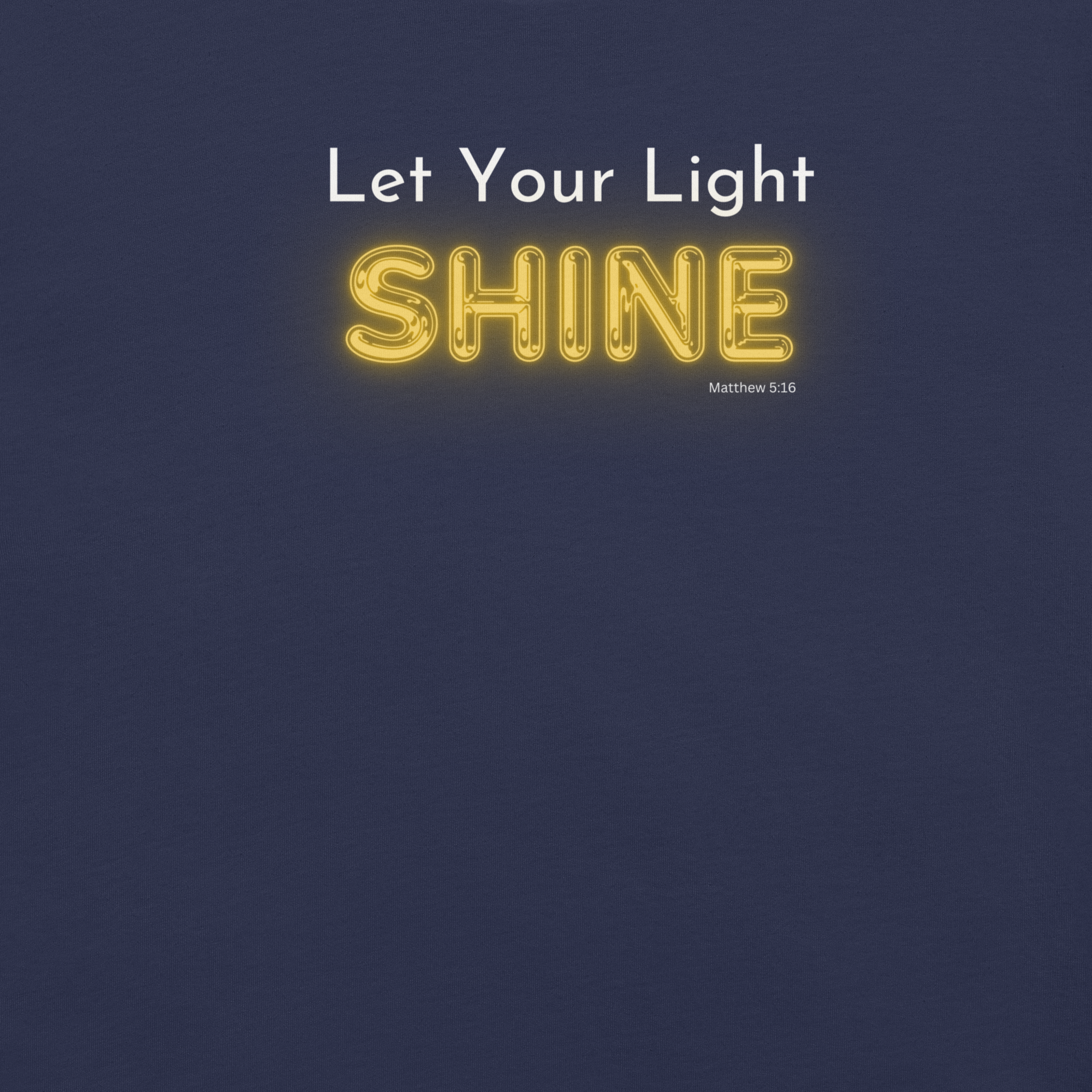 Close-up of glowing 'Shine' text on 'Let Your Light Shine' navy T-shirt.