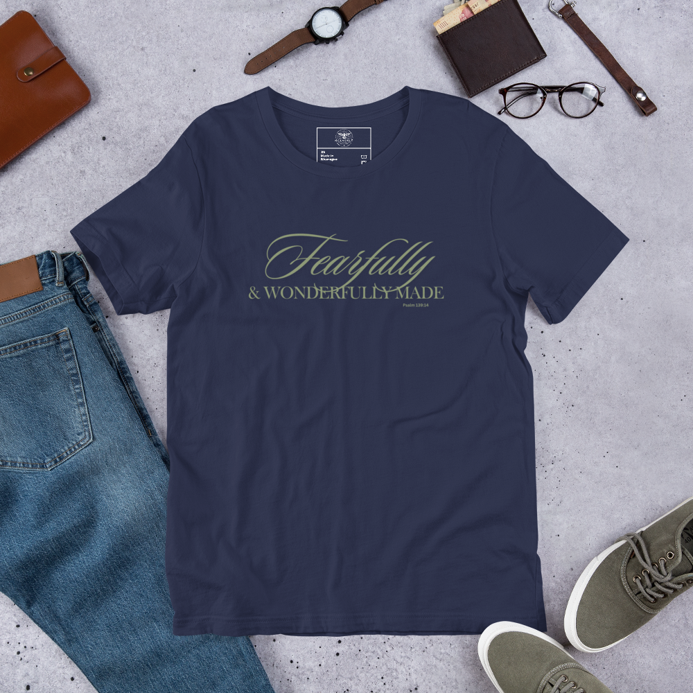 "Display of 'Wonderfully Made' T-shirt in Navy with gold script in a shop setting."