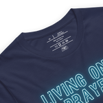 Close-up of neon 'Living on a Prayer' text on navy T-shirt, glowing effect.