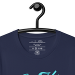 Navy 'In His Grace' T-shirt on a wooden hanger, showcasing the front script,  Inside label of 'In His Grace' T-shirt showing fabric and care instructions Heavenly Crafted Online Store