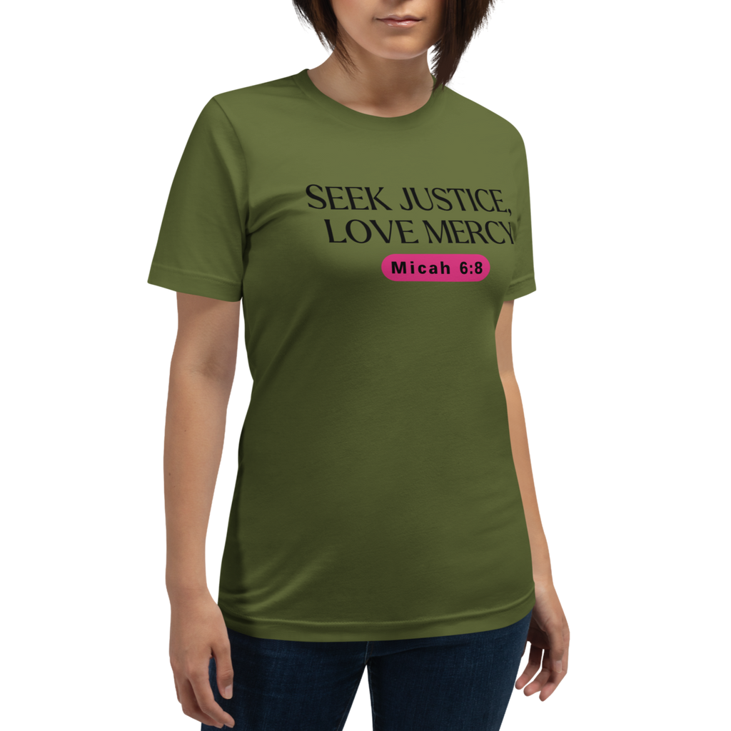 Model wearing the 'Army of Faith' T-shirt in Army Green, shown from a three-quarter view. Features bold black text and a pink button-like design, offering a stylish and comfortable expression of faith.