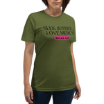 Model wearing the 'Army of Faith' T-shirt in Army Green, shown from a three-quarter view. Features bold black text and a pink button-like design, offering a stylish and comfortable expression of faith.