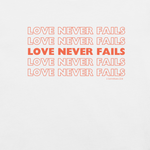 Inside label of 'Love Never Fails' T-shirt showing care instructions.