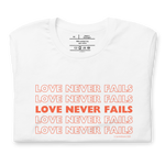 Folded White T-shirt with 'Love Never Fails' in red outline script.