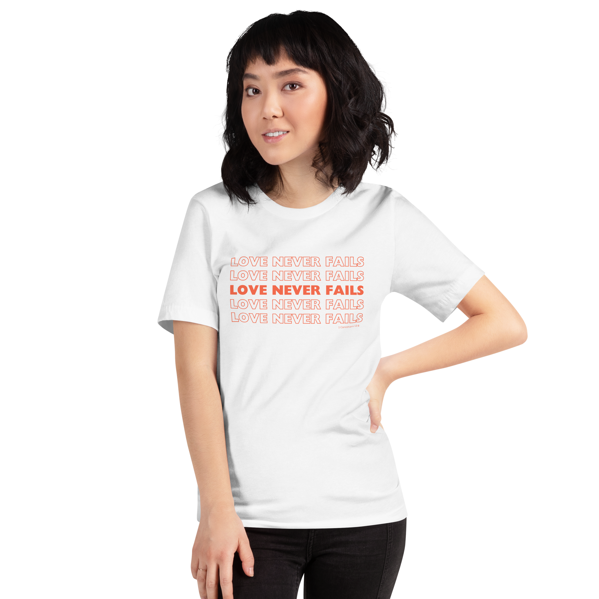 Model wearing 'Love Never Fails' T-shirt in White, side view.