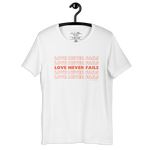 White 'Love Never Fails' T-shirt on wooden hanger.