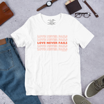 Display of 'Love Never Fails' T-shirt in White on shop storefront.