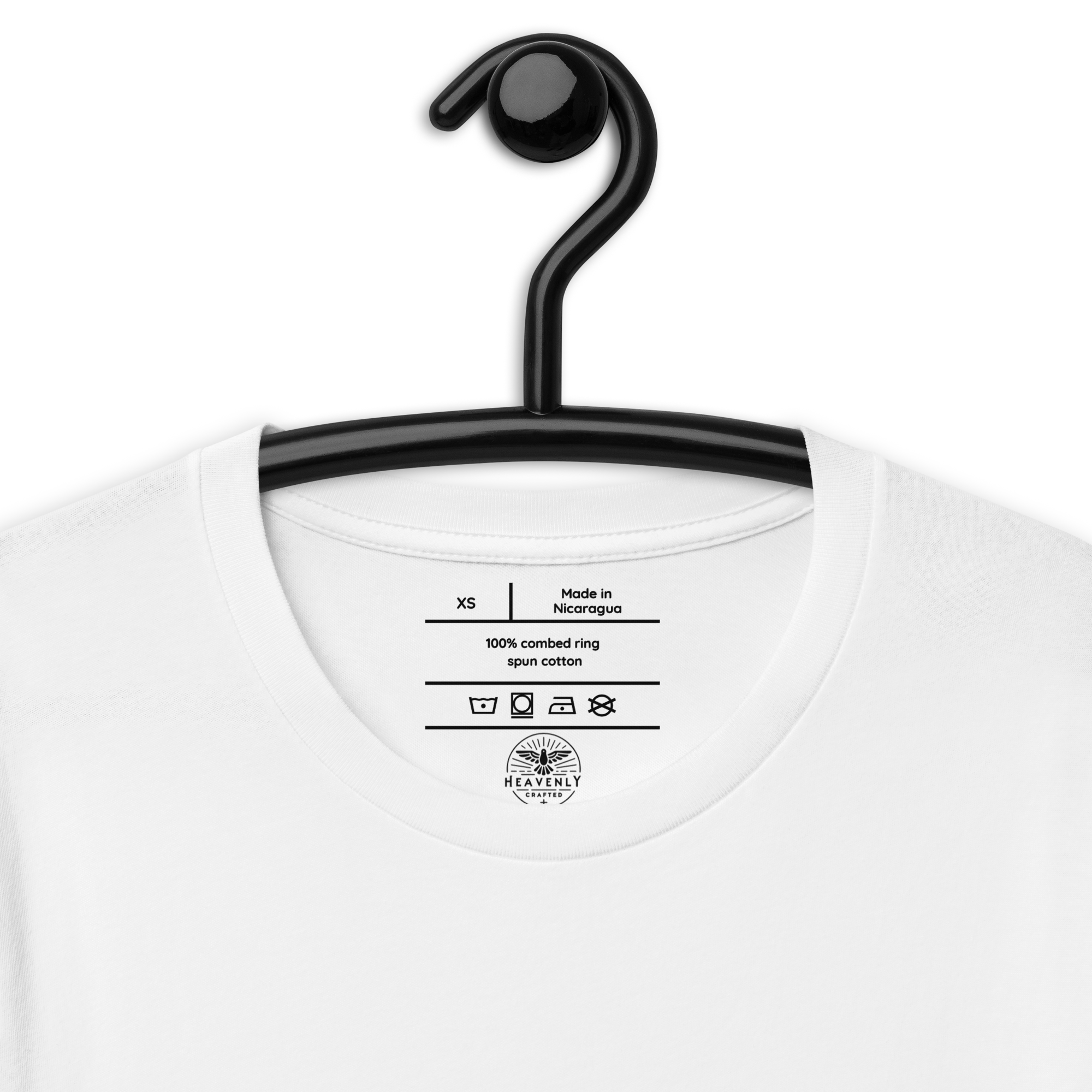 White 'Love Never Fails' T-shirt on wooden hanger.. Close-up of 'Love Never Fails' text on White T-shirt.